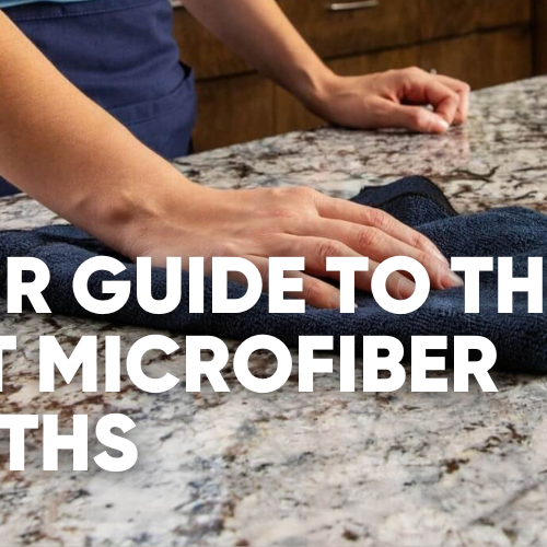 Person cleaning a countertop with a microfiber cloth.