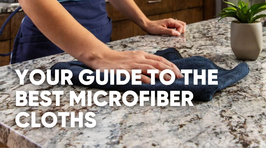 Person cleaning a countertop with a microfiber cloth.