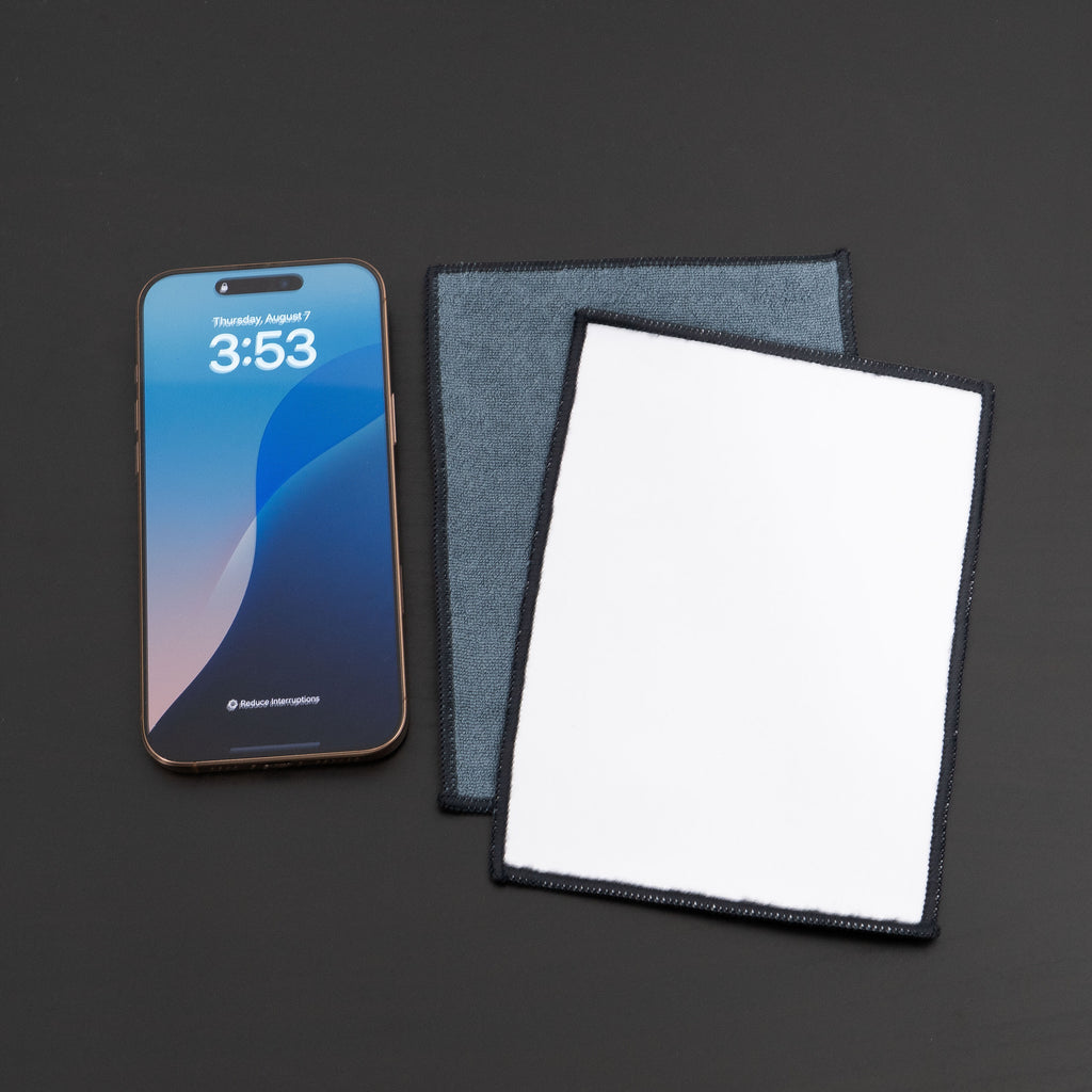 microfiber lens cloth on a desk and iphone