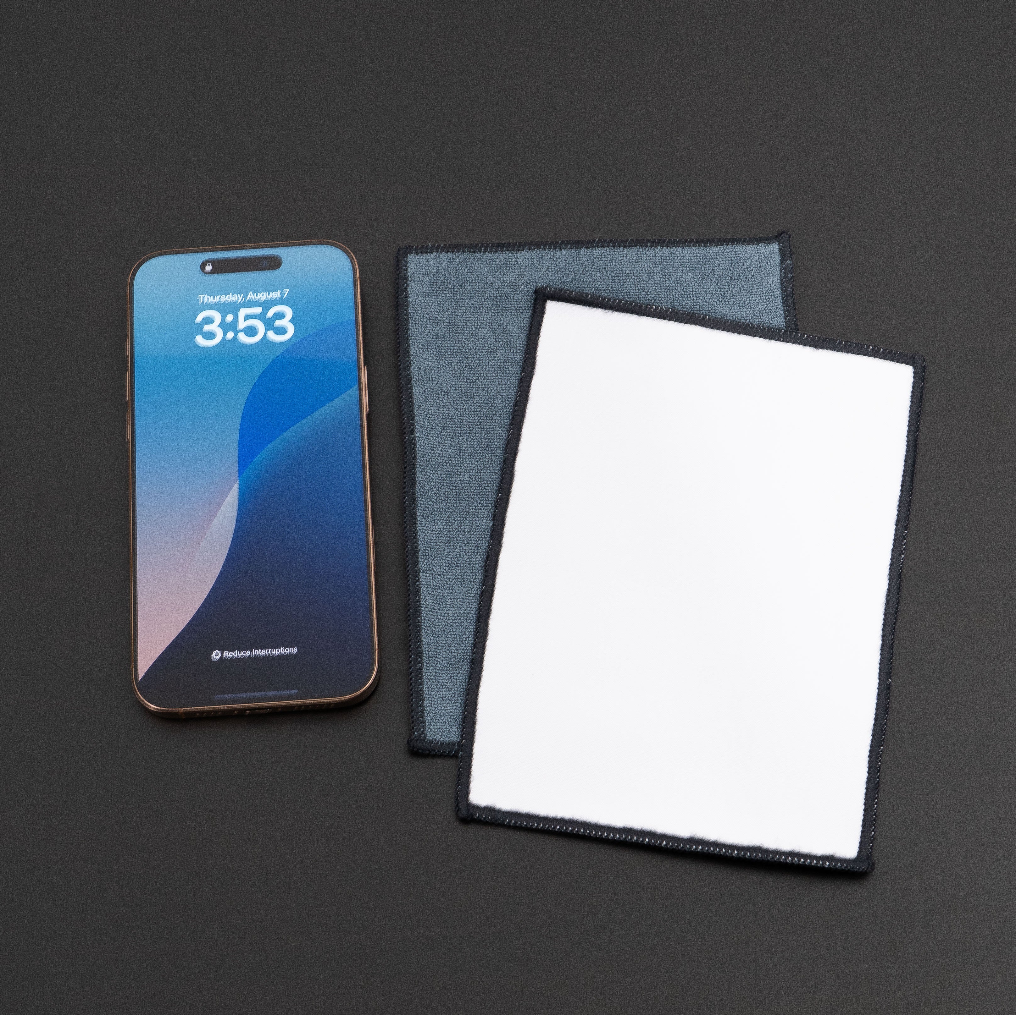 microfiber lens cloth on a desk and iphone