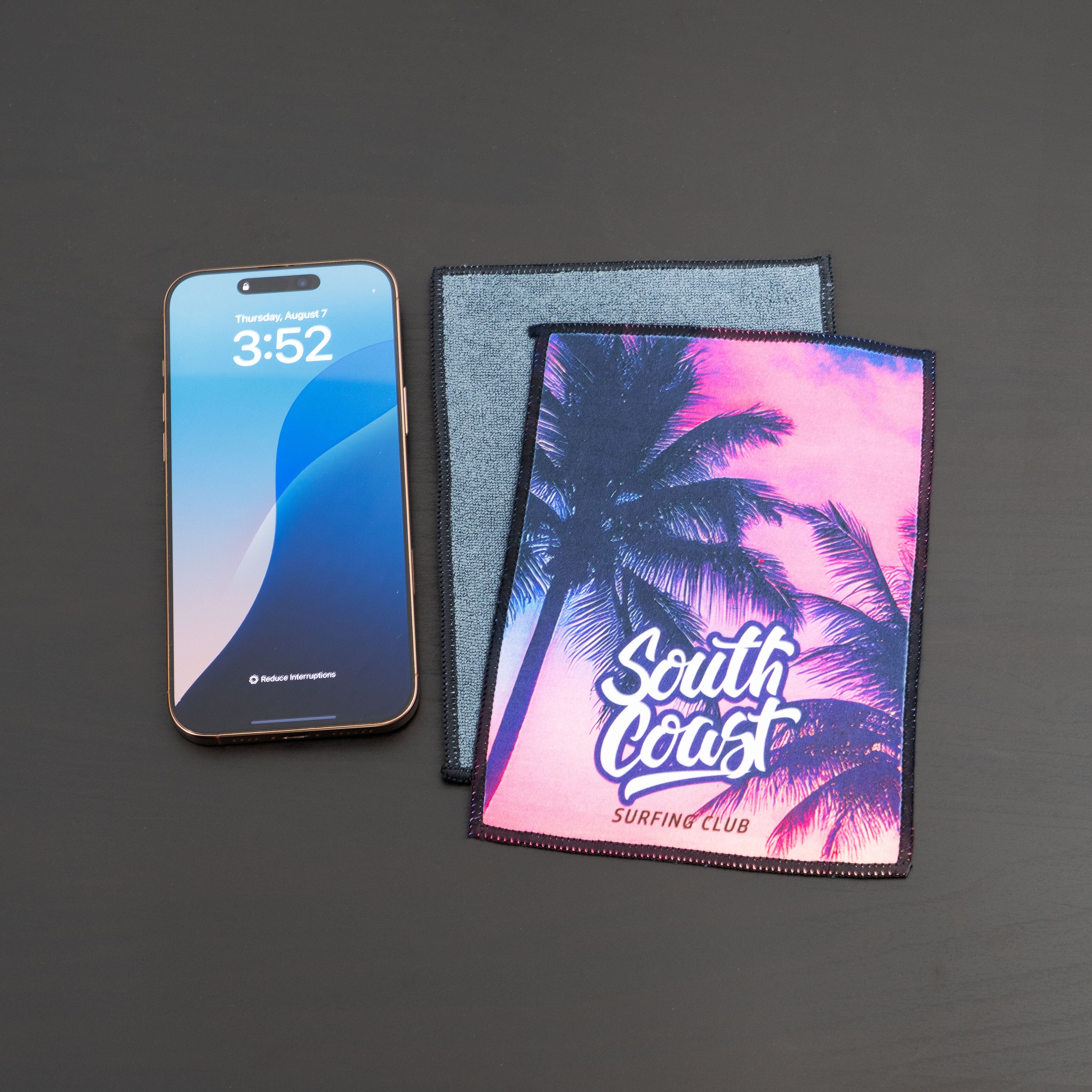 microfiber lens cloth on a desk and iphone