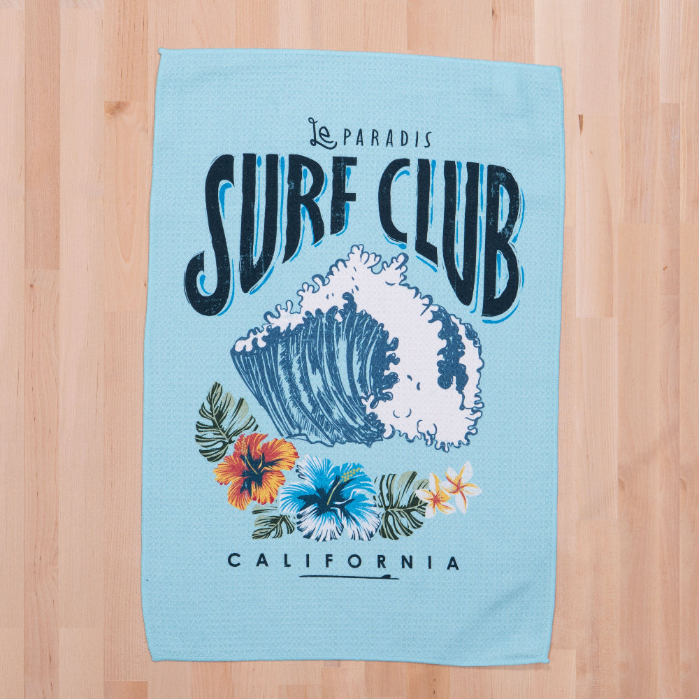 surf club printed waffle towel on a wooden countertop