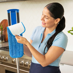 cleaner removing a microfiber mop pad off a mop frame