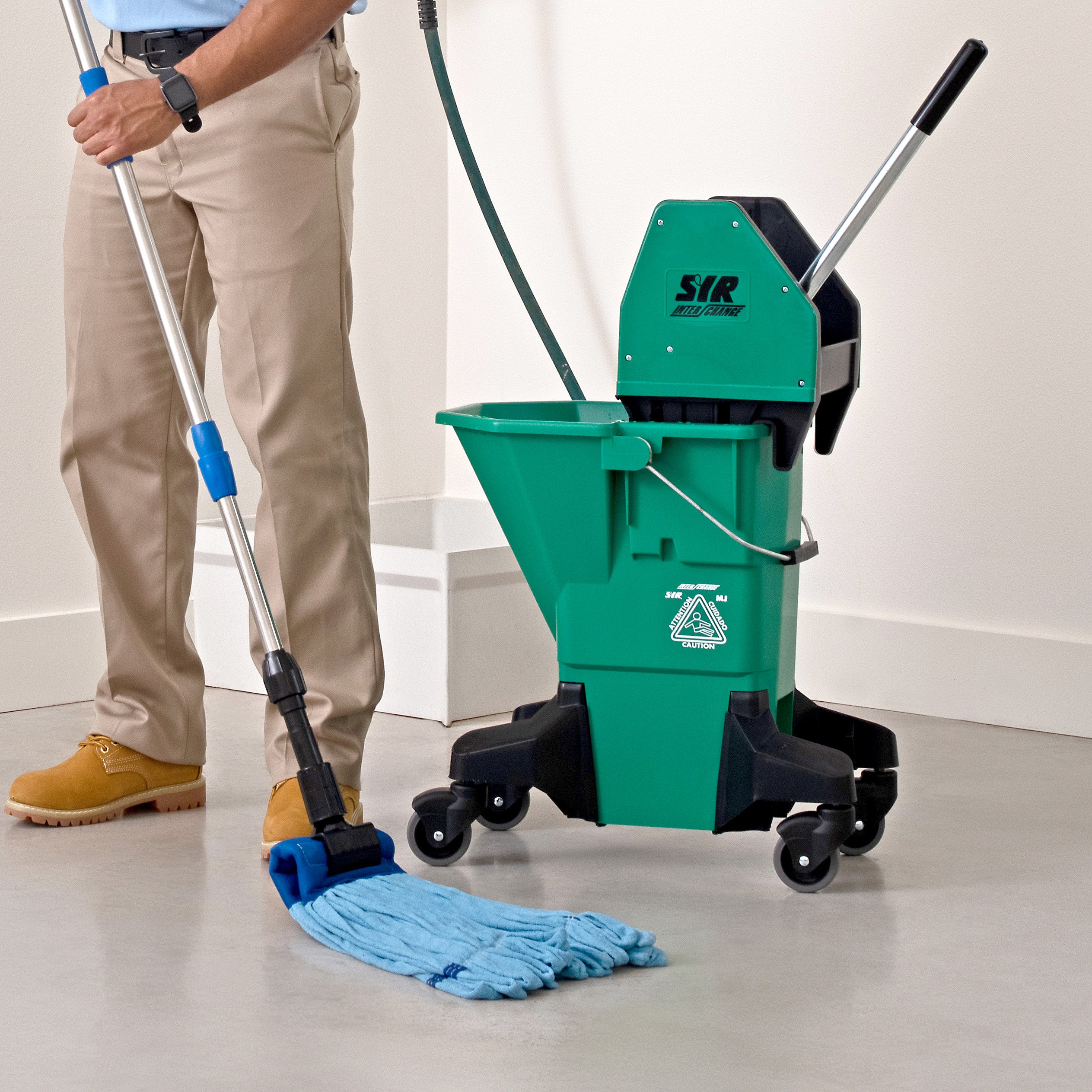 man mopping concrete with a blue microfiber tube mop and green bucket