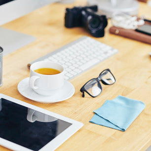 silk lens cloth on a desk with glasses, ipad and coffee cup