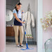 a woman in a bathroom mopping with a microfiber flat mop