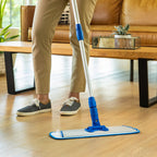 a person mopping hardwood floors with a microfiber flat mop